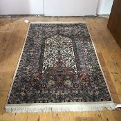 An Isfahan prayer rug, the central panel on an ivory ground decorated with interlacing scroll motifs