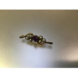 A 9ct gold amethyst and cultured pearl brooch, hallmarked for PJD, Edinburgh 1988, centred by an