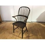 A small oak and elm hoop back Windsor armchair, 19th century, the stick back above a saddle seat