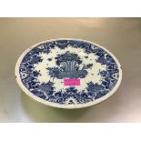 A blue and white faience tazza, 18th century, possibly Rouen, the circular dish painted to the