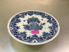 A blue and white faience tazza, 18th century, possibly Rouen, the circular dish painted to the