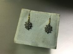 A pair of diamond cluster earrings, each centred by a marquise-cut stone claw-set within a band of