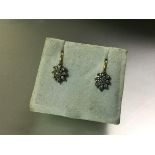 A pair of diamond cluster earrings, each centred by a marquise-cut stone claw-set within a band of