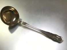 A substantial German 800 silver soup ladle, c. 1900, with gilt bowl and shaped thread handle,
