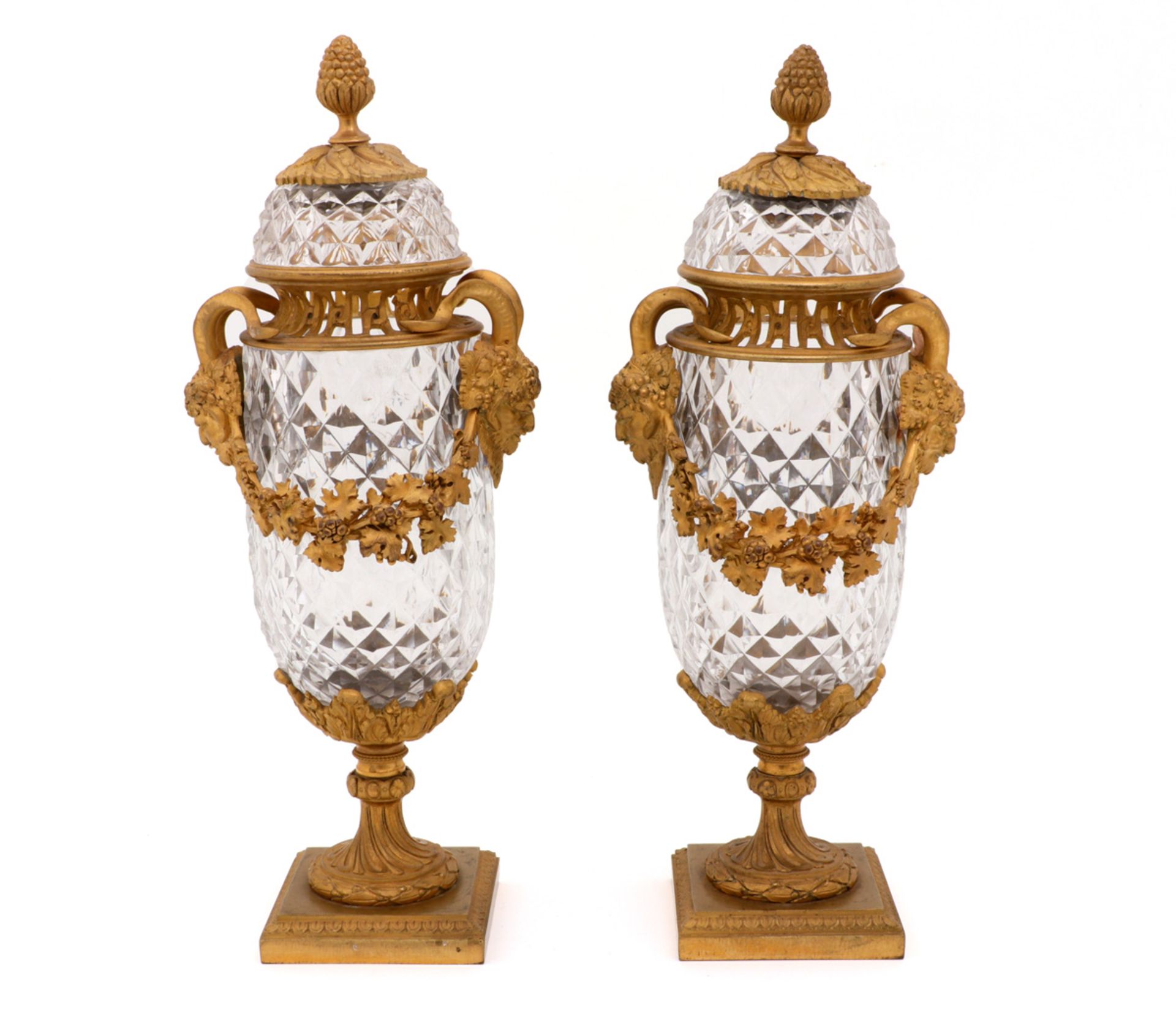 A PAIR OF LOUIS XVI COVERED URNS Faceted and engraved crystal, ormolu mounts with fauns and grape