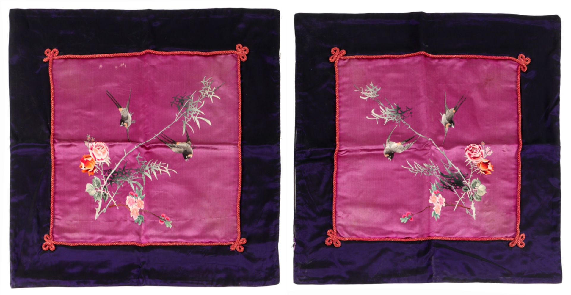 A PAIR OF ORIENTAL PILLOWS Embroidered silk, polychrome decoration depicting birds and peonies, on a