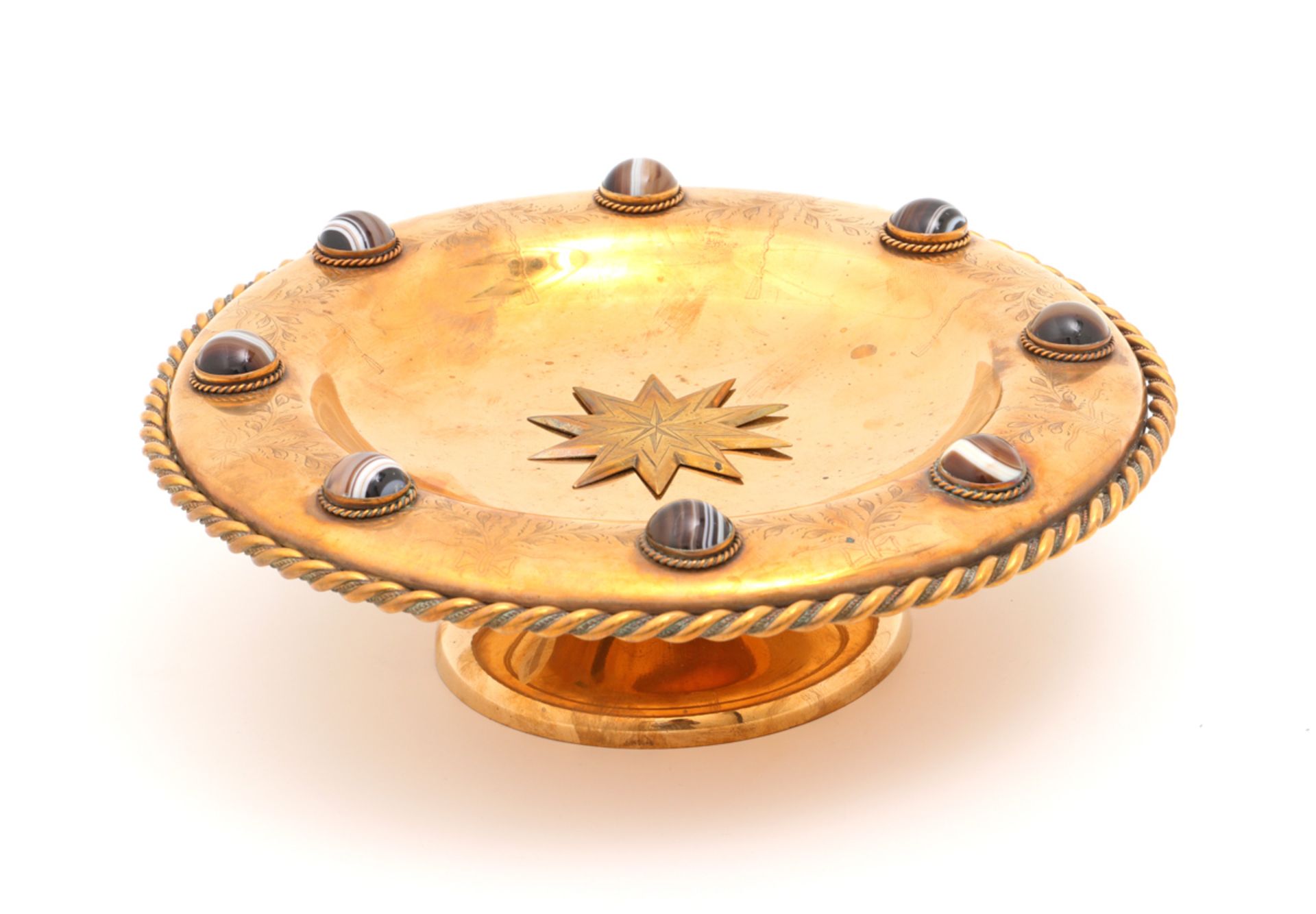 A VICTORIAN BOWL Brass, decoration in relief with garlands and agate cabochons. Scotland, mid 19th