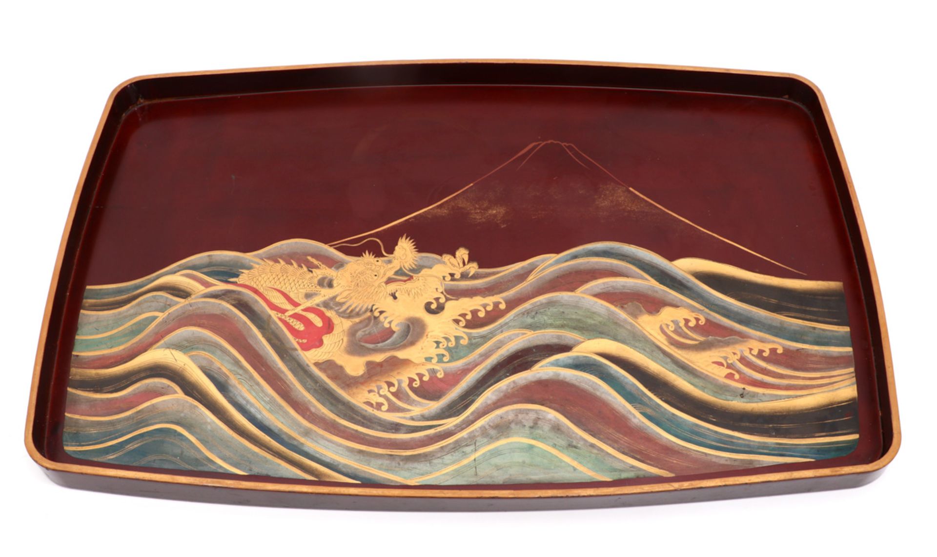 A JAPANESE TRAY Lacquered wood, gilt decoration depicting sea with dragon and vulcano. Japan,