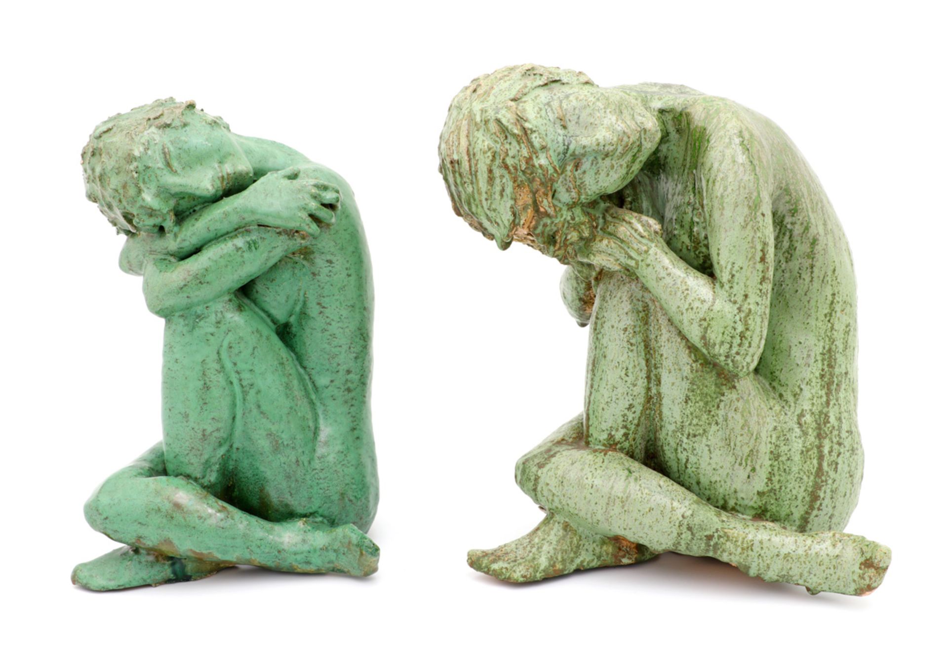 TWO SEATED FEMALE FIGURES Glazed terracotta sculptures, celadon decoration, depicting seated