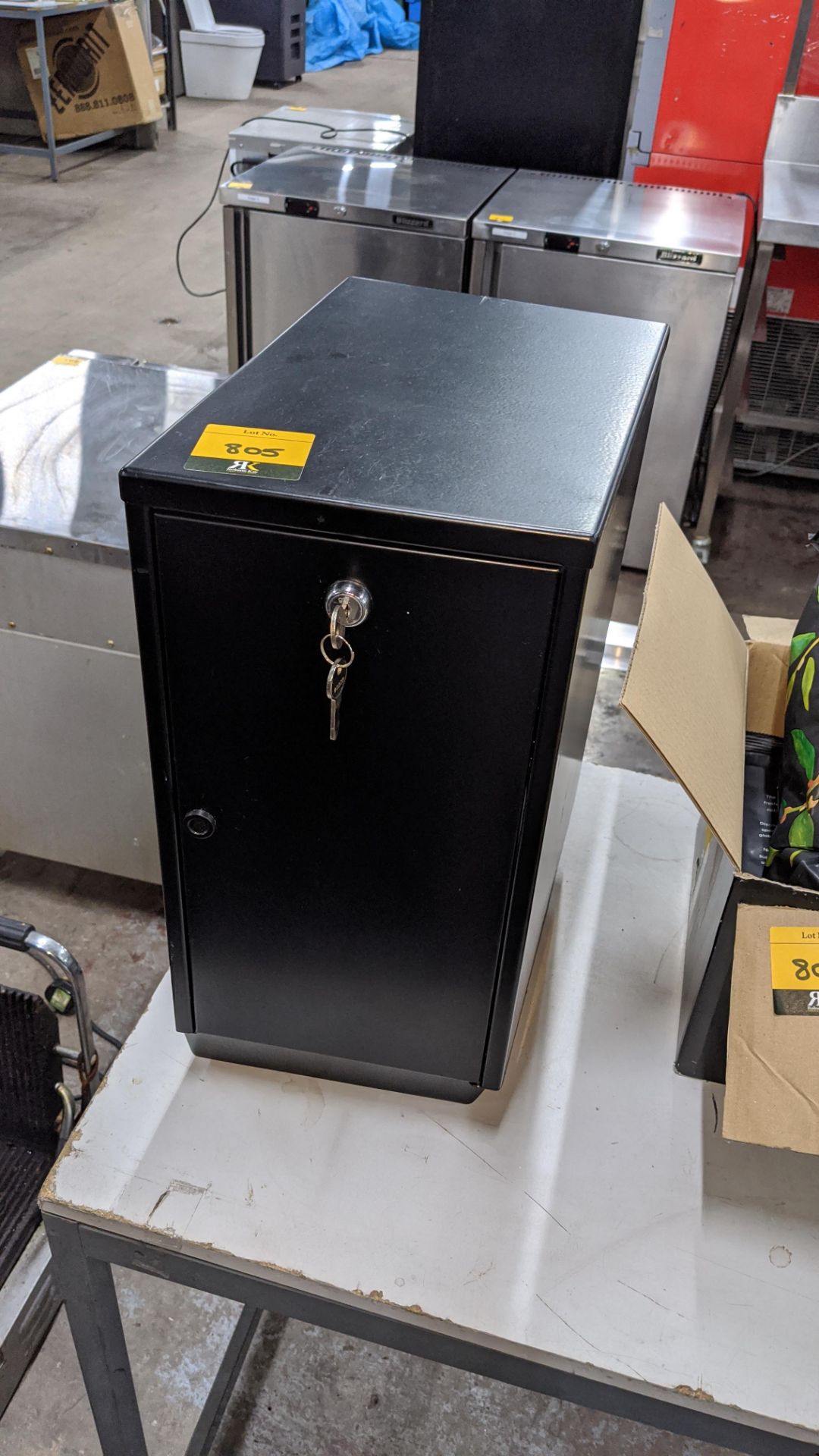 Small black metal lockable unit with keys, max external dimensions circa 210mm width x 315mm depth x