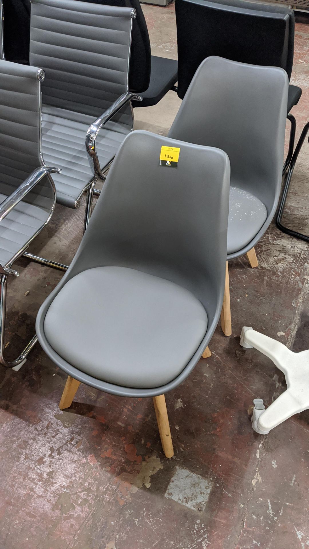 Pair of matching modern chairs in pale grey on wooden legs. This is one of a small number of lots
