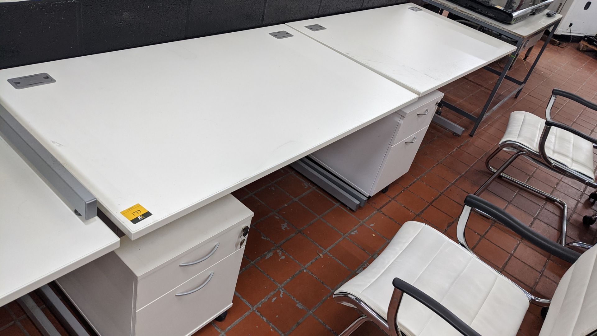 2 off white desks on silver grey metal frames, each desk being 1400mm wide & 800mm deep. Cable