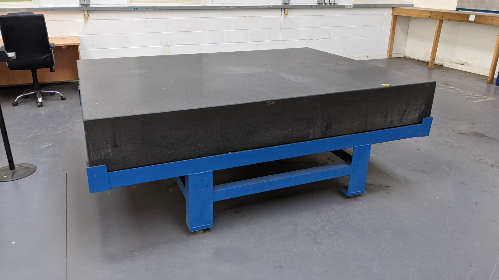 Large granite table on metal frame with adjustable feet. Granite block measures approx. 2440mm x