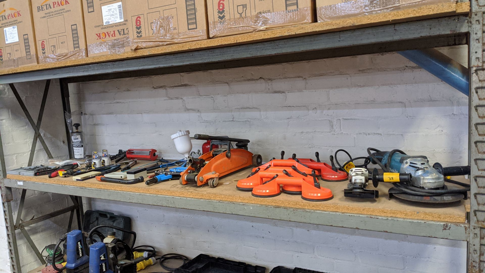 Contents of a shelf of assorted tools including Makita small & large angle grinders, suction - Image 2 of 9