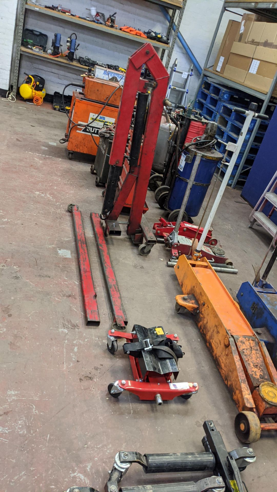 Assorted lifting equipment comprising transmission jack, mobile hoist & trolley with contents.