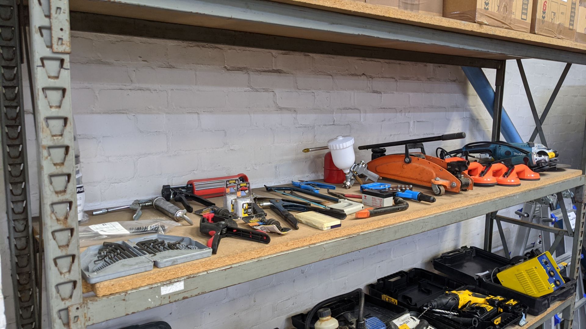 Contents of a shelf of assorted tools including Makita small & large angle grinders, suction - Image 9 of 9