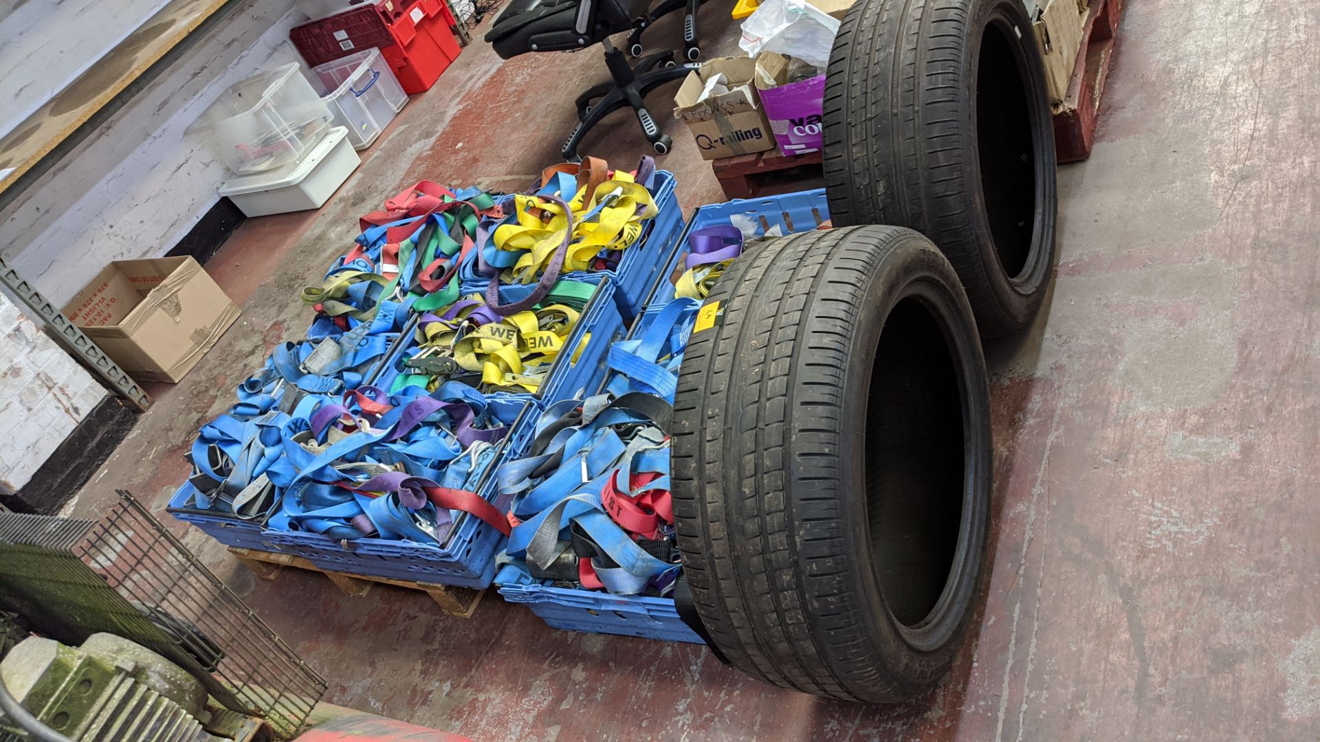 Contents of 8 crates of ratchet tie-down & other straps plus 2 tyres - crates excluded. Lots 22 - 53