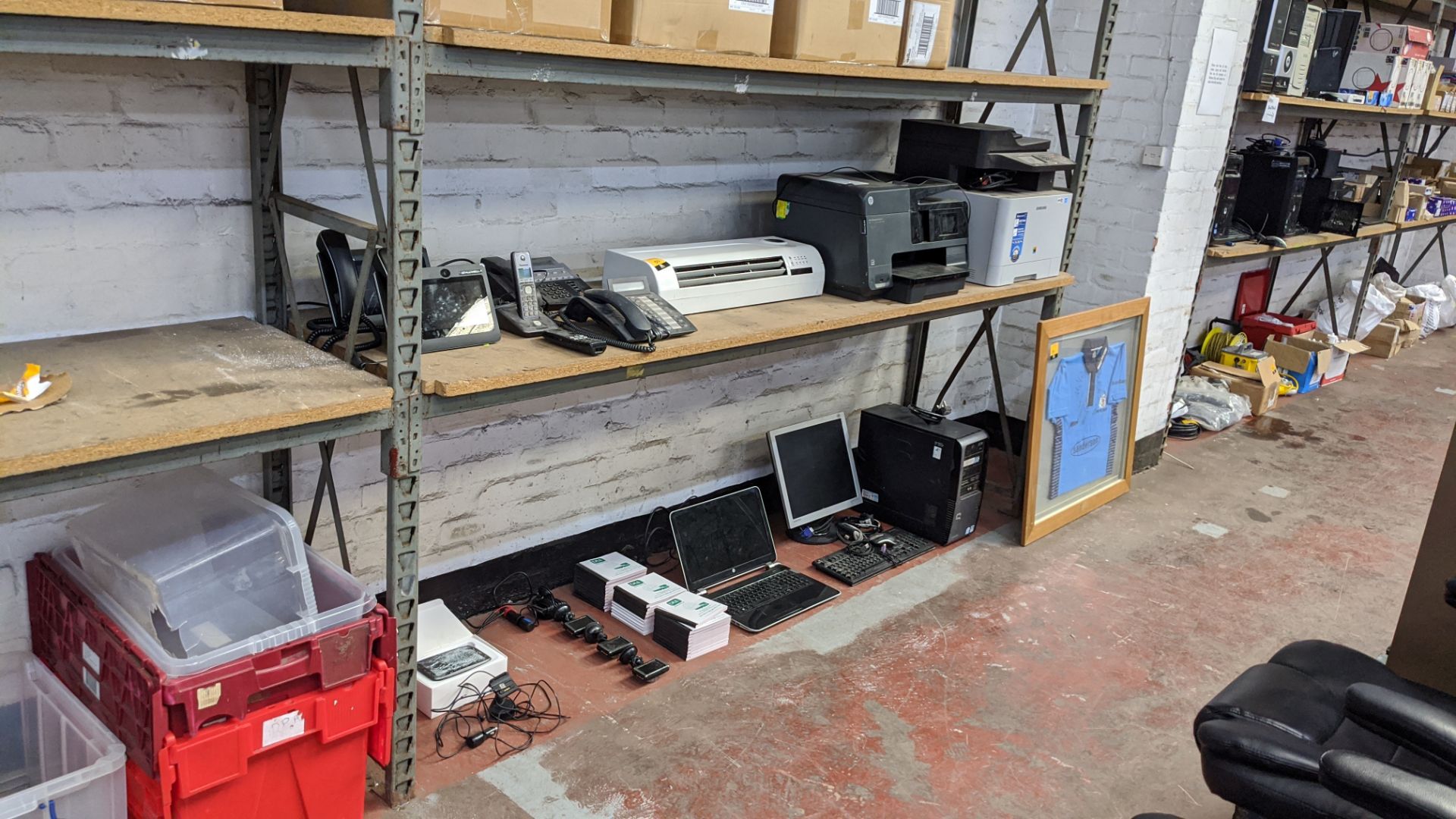 Contents of 2 shelves of assorted IT equipment including telephones, printers, computers, dash cams,