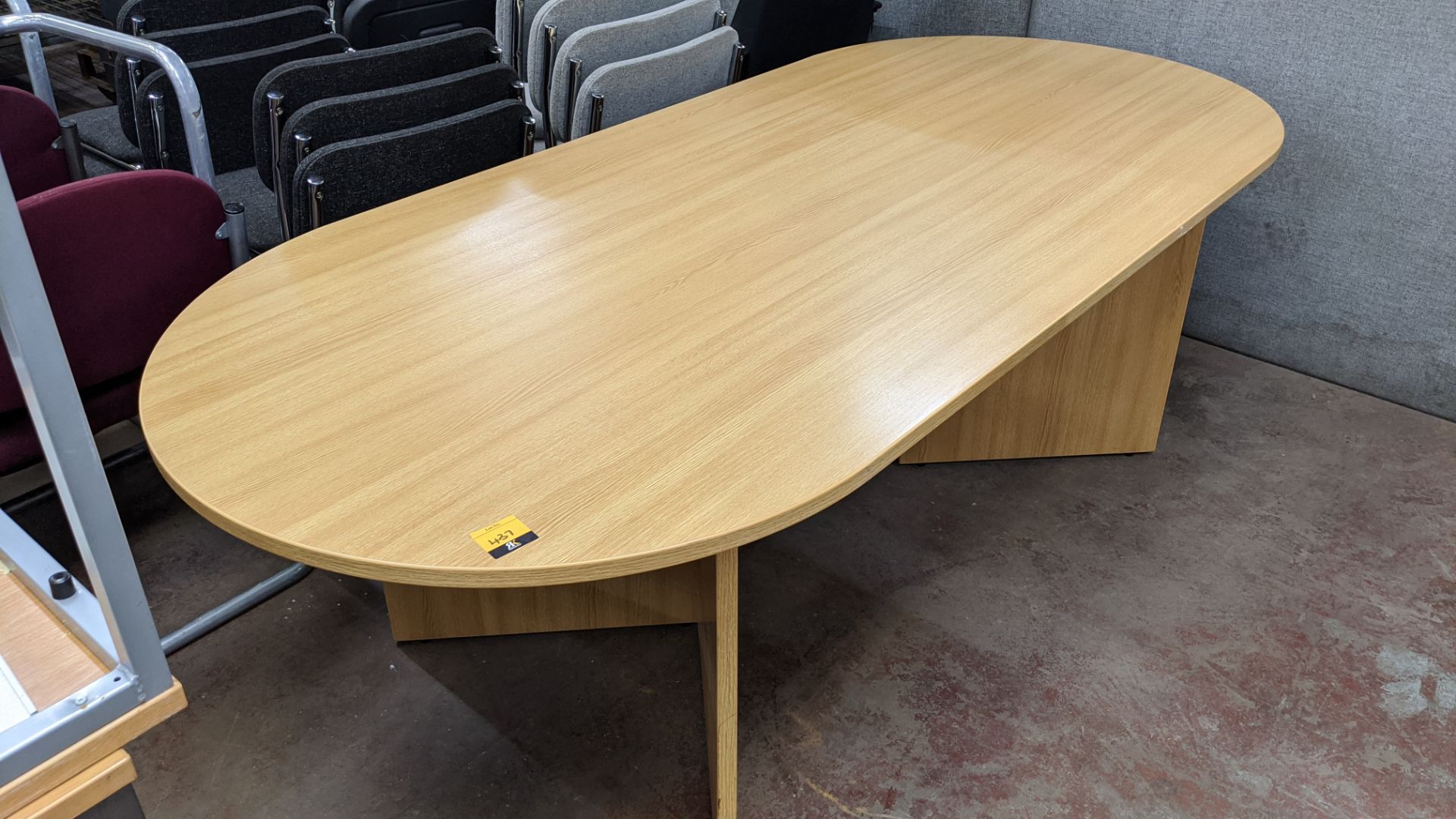 Light oak oval meeting table, measuring approx. 2200mm x 1000mm x 720mm