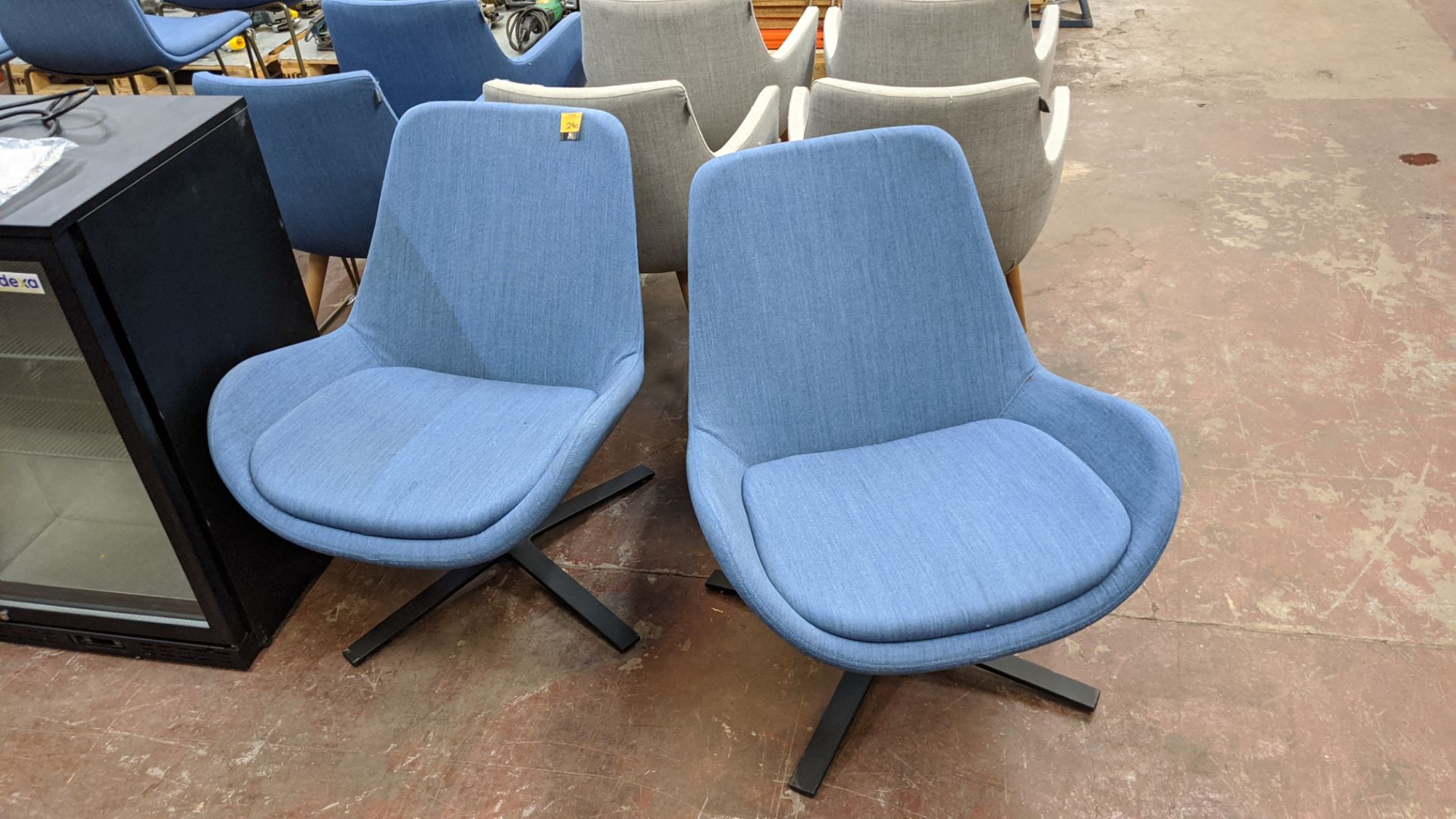 Pair of blue fabric upholstered swivel chairs NB. The fabric appears to match that used for lots 29