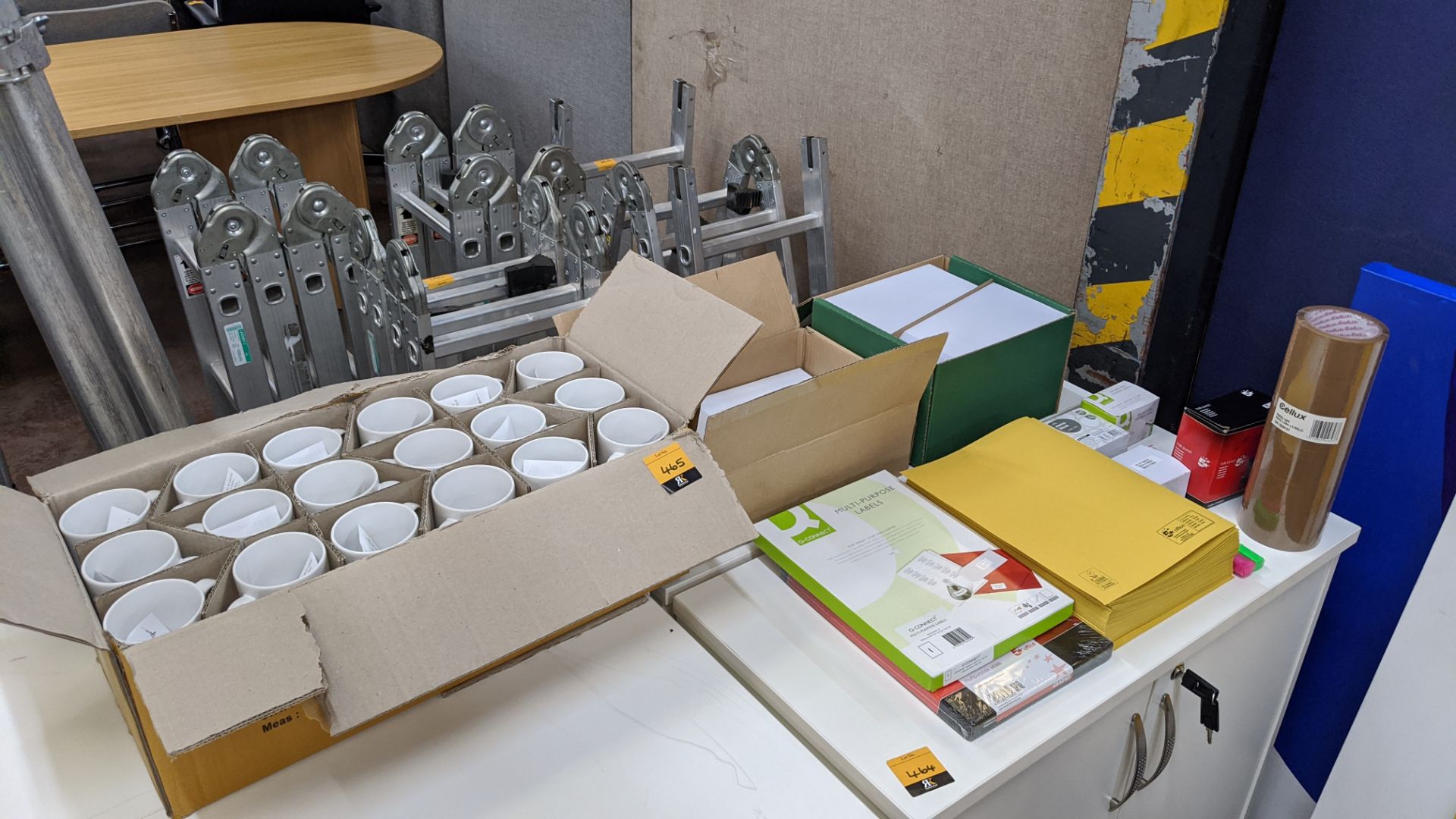 Office sundries comprising box of branded mugs plus quantity of envelopes, paper, labels, tape, etc.