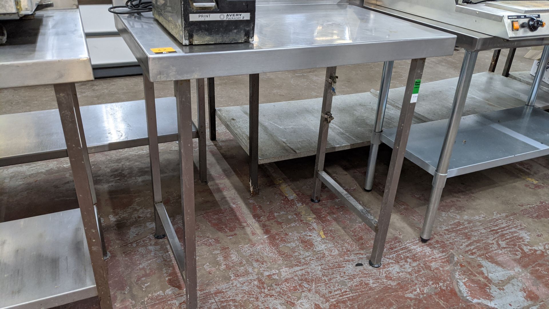 Stainless steel table, table top measuring approximately 900mm x 600mm