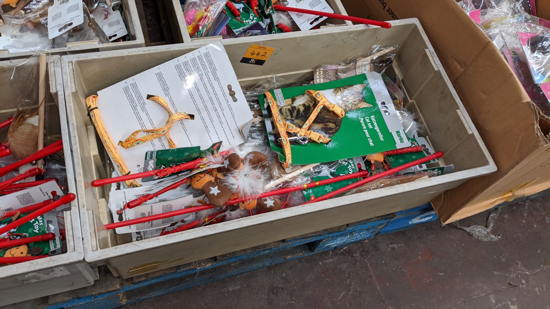 The contents of a crate of assorted cat toys, novelties, harnesses, leads & more