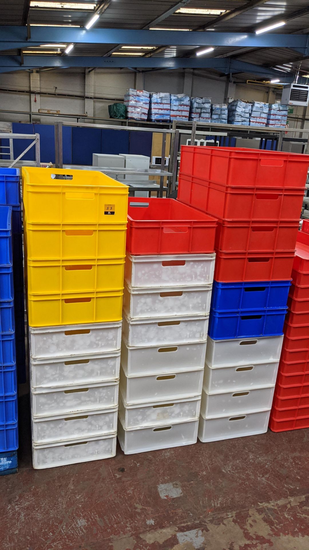 27 off large plastic stacking crates in a variety of colours, each crate measuring 450mm x 760mm x 1