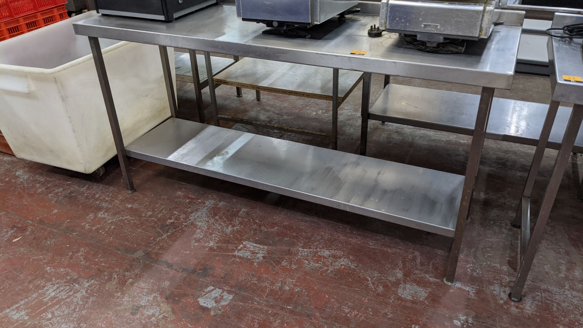 Stainless steel twin tier table, table top measuring approximately 1795mm x 600mm