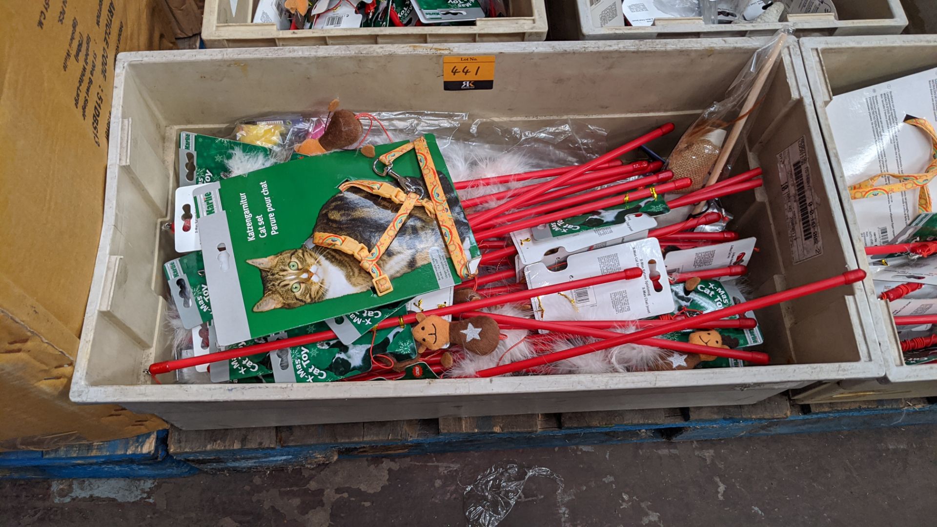 The contents of a crate of assorted cat toys, novelties, harnesses, leads & more