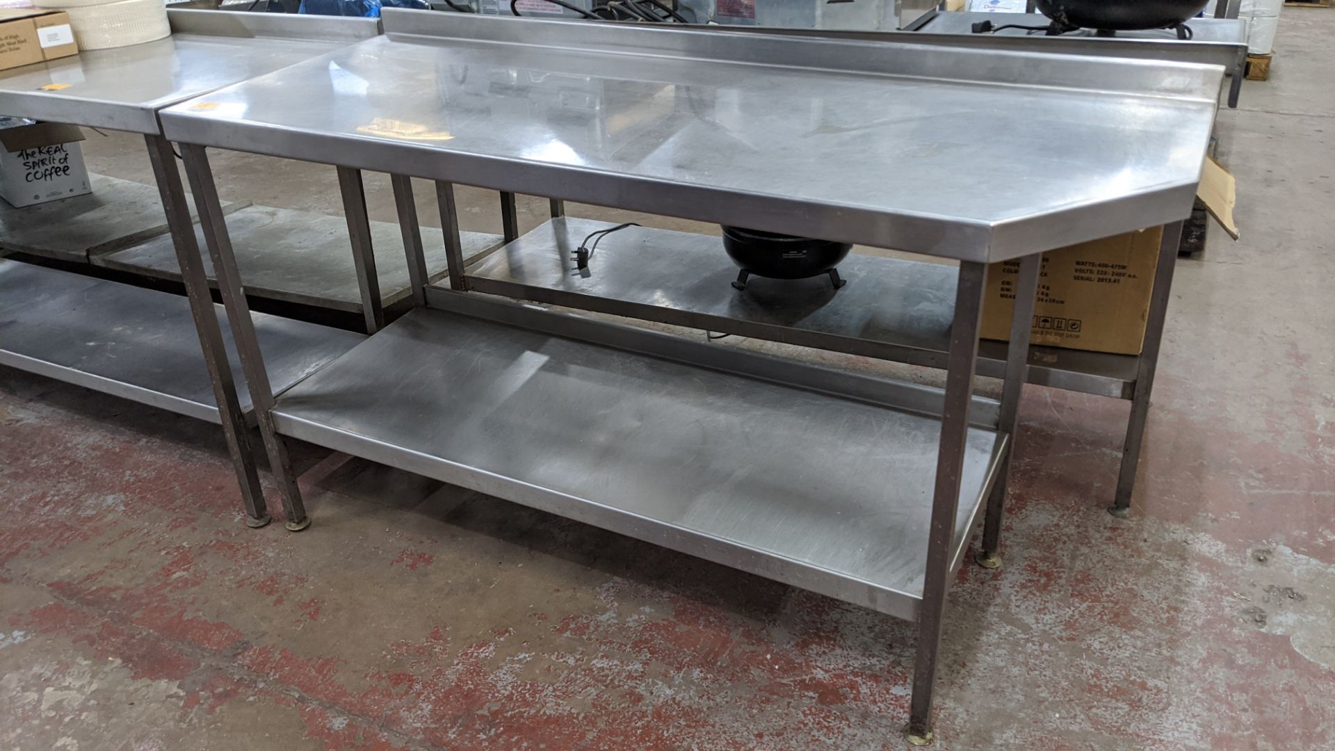 Stainless steel twin tier table with top measuring approximately 1600mm x 600mm at extremes (please - Image 3 of 3