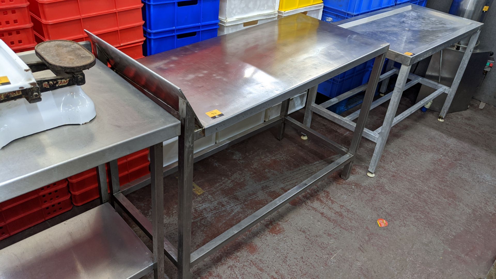 Stainless steel table, with angled top. Max external dimensions approx. 1350mm x 600mm