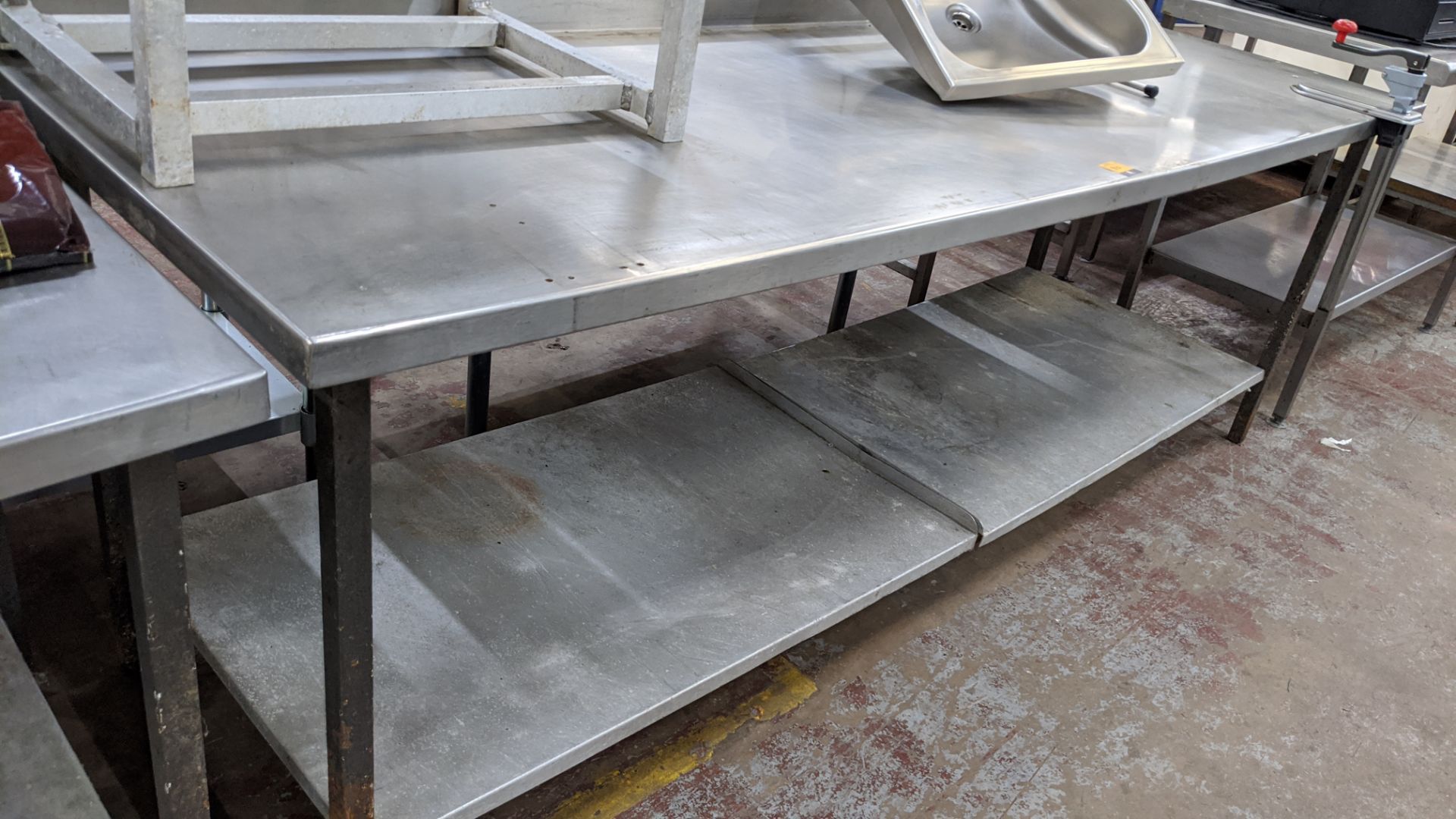 Large stainless steel twin tier table with Bonzer commercial can opener attached to same - table top