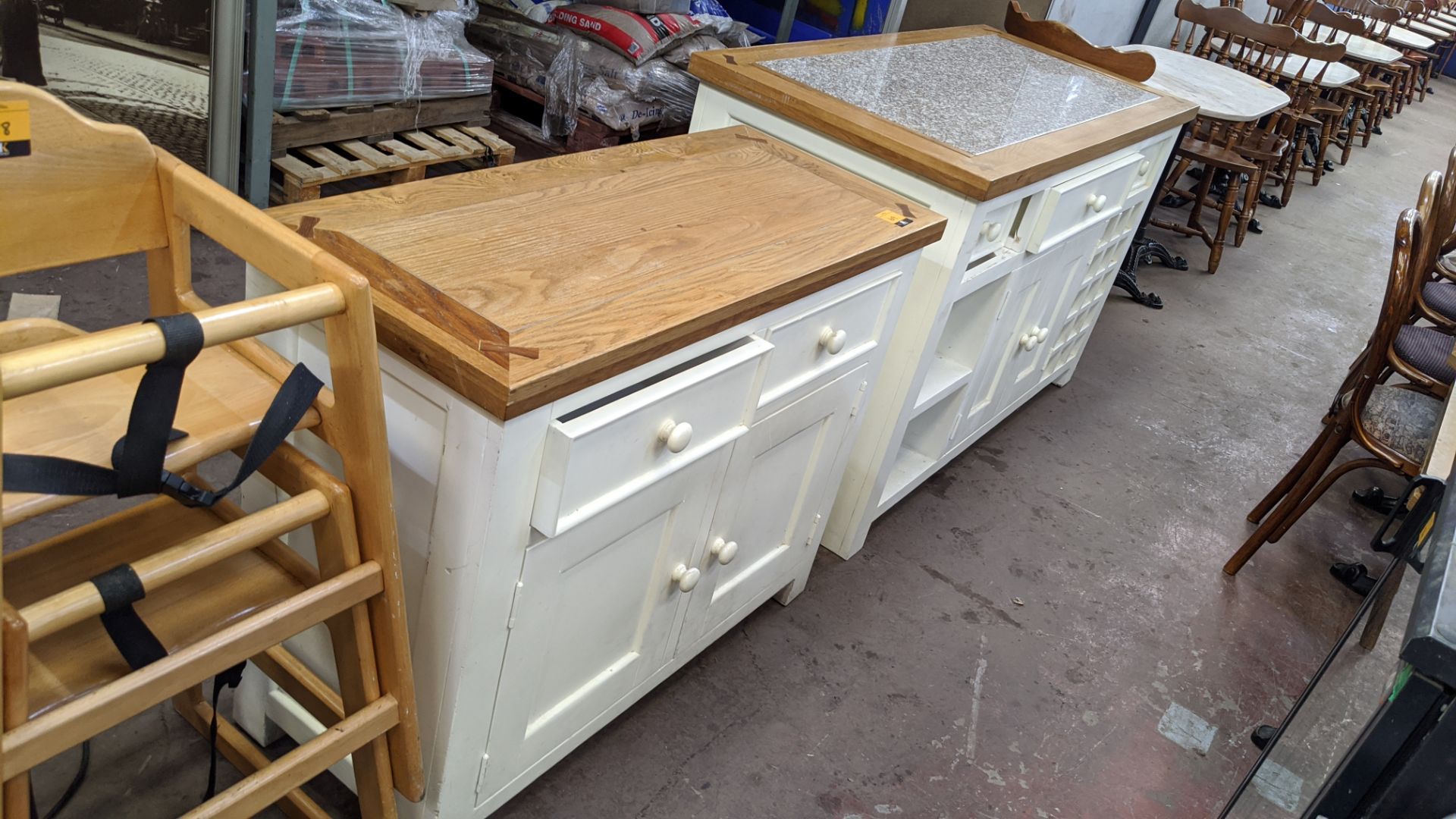 Pair of matching cupboards/sideboards in cream/white paint with wooden top, one of the units having