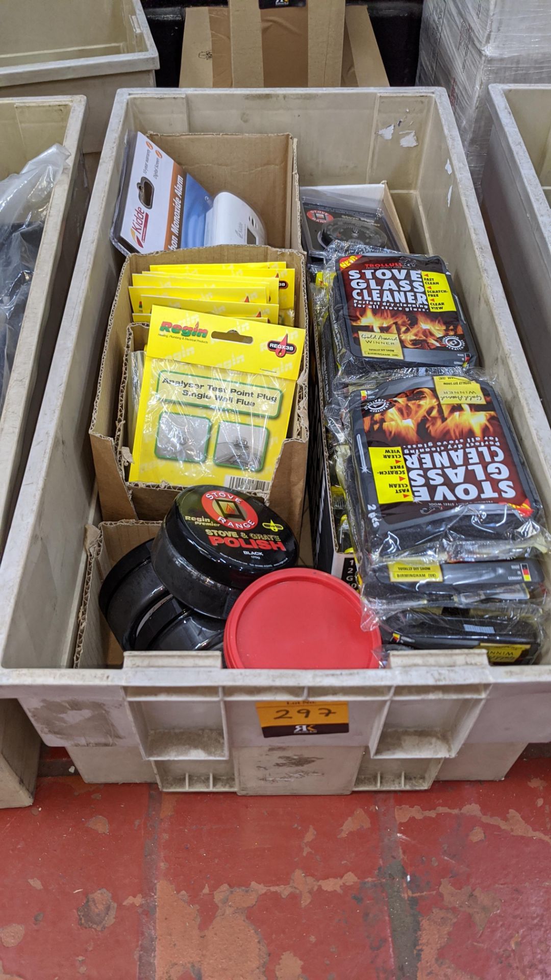 The contents of a crate of miscellaneous items including carbon monoxide alarm, stove polish, thermo