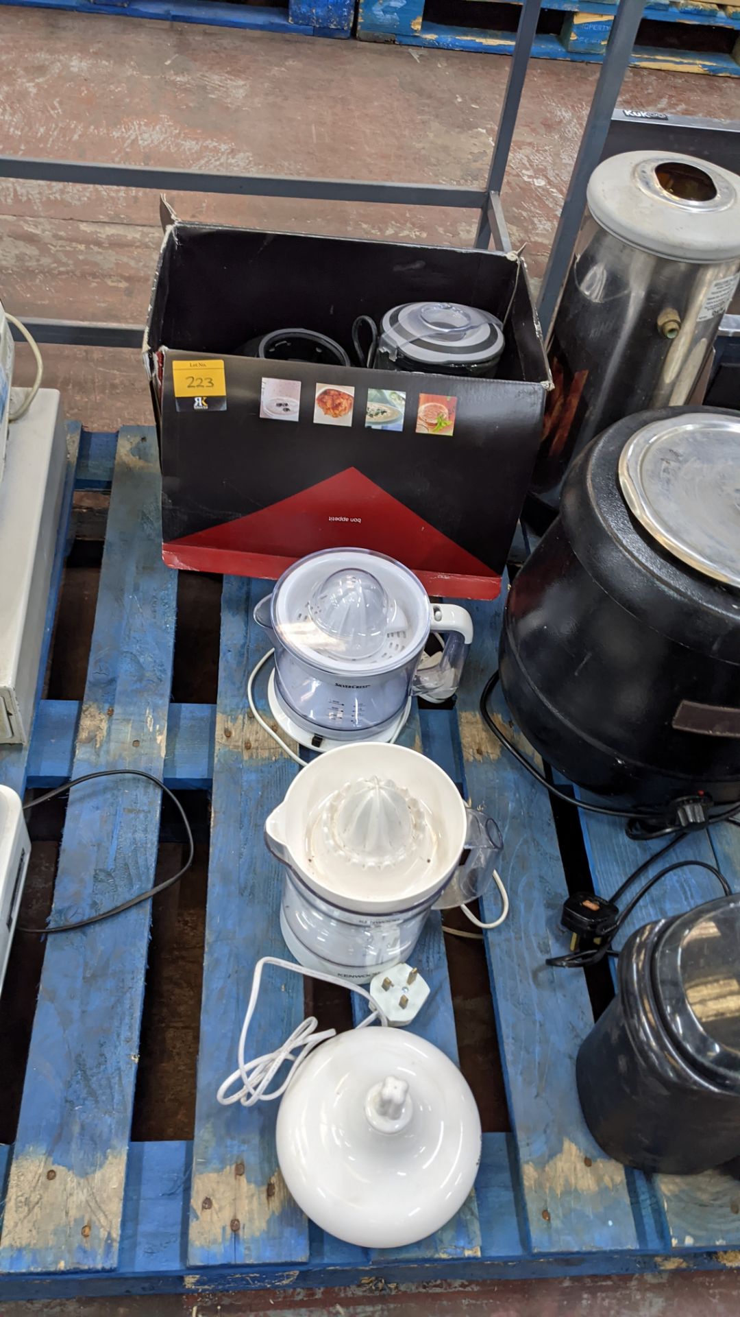 Row of assorted electric blenders, juicers and similar