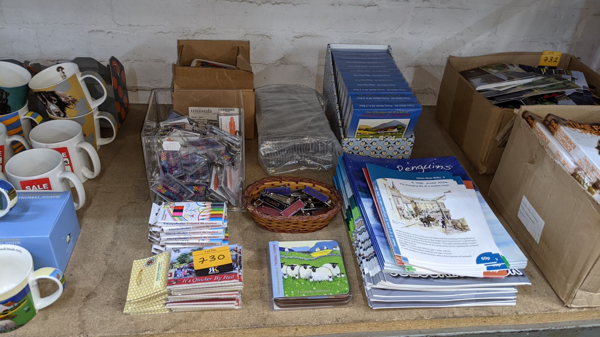 Large quantity of assorted gift items including keyrings, crayons, fridge magnets, books, embroidery