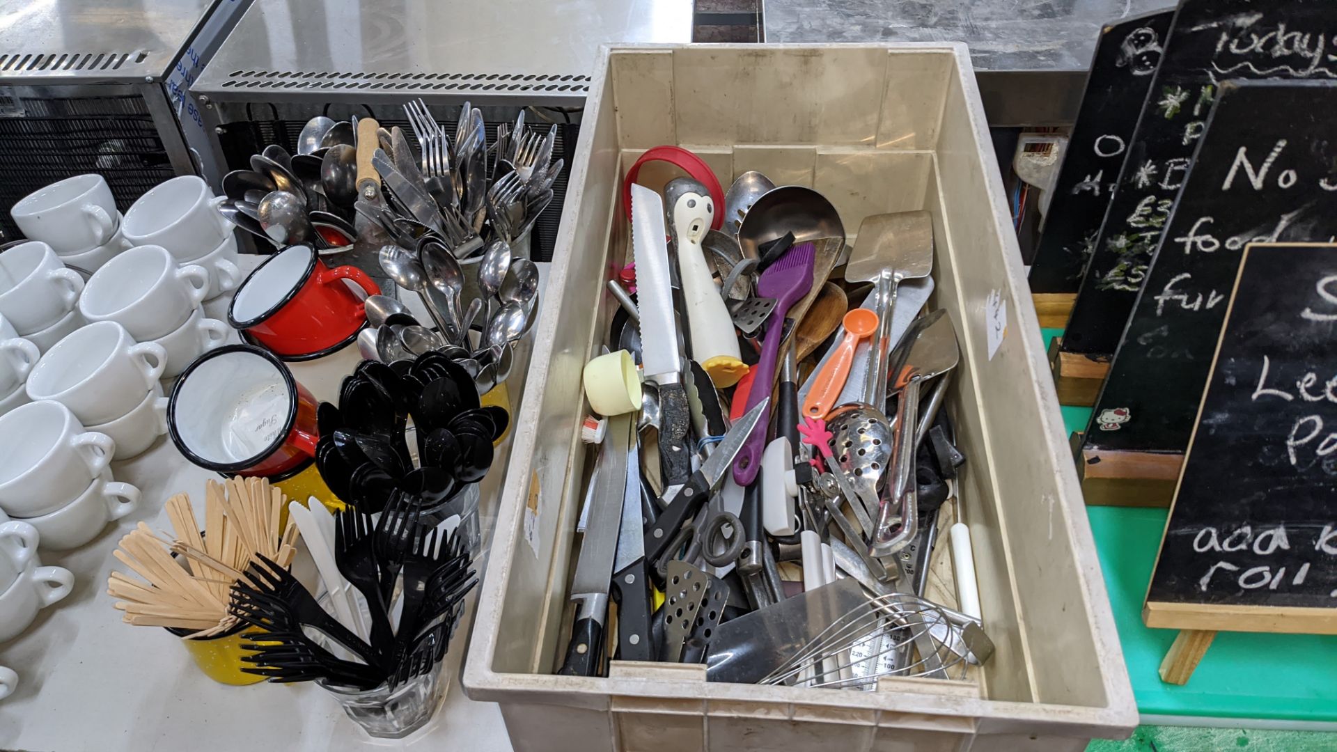 The contents of a table comprising white cups & saucers plus cutlery, utensils, chopping boards, min - Image 5 of 6