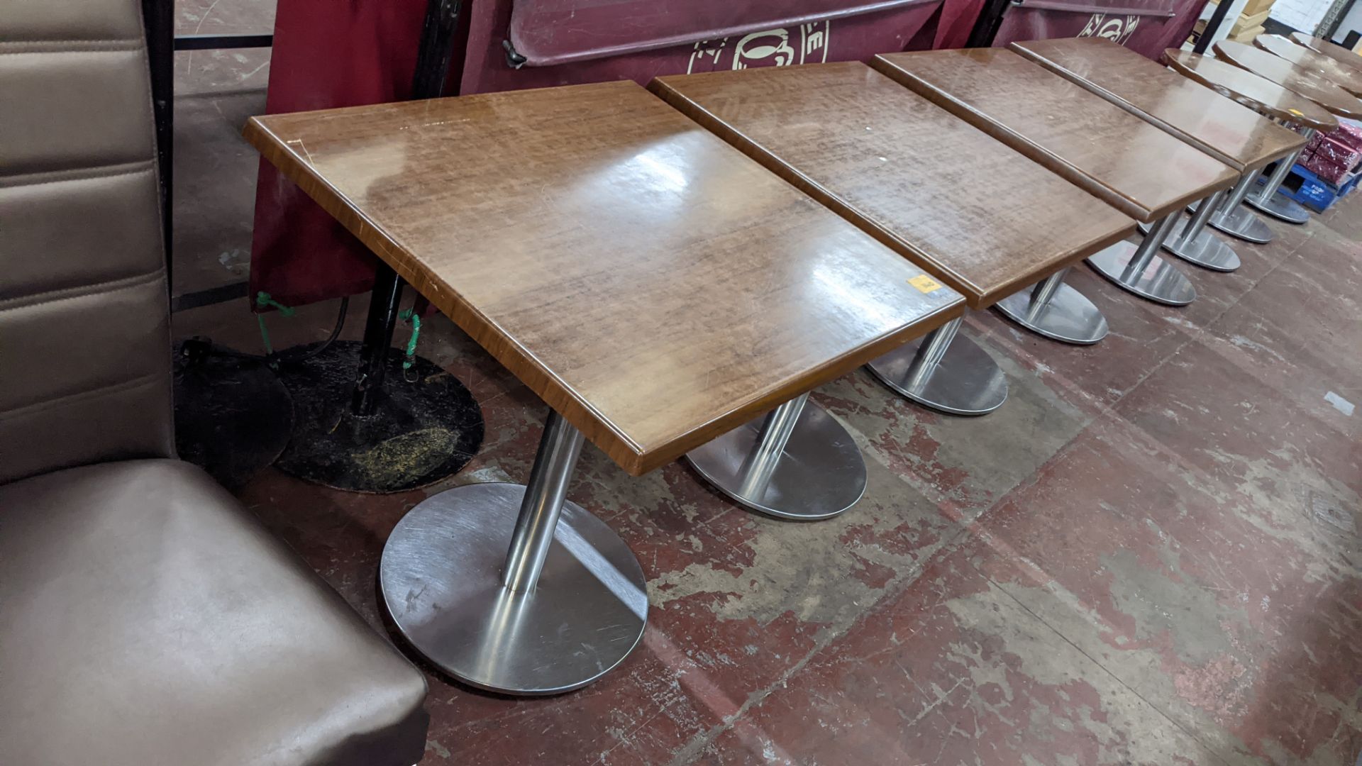 4 off square dining tables on metal single pedestal bases, the tops measuring approximately 700mm sq
