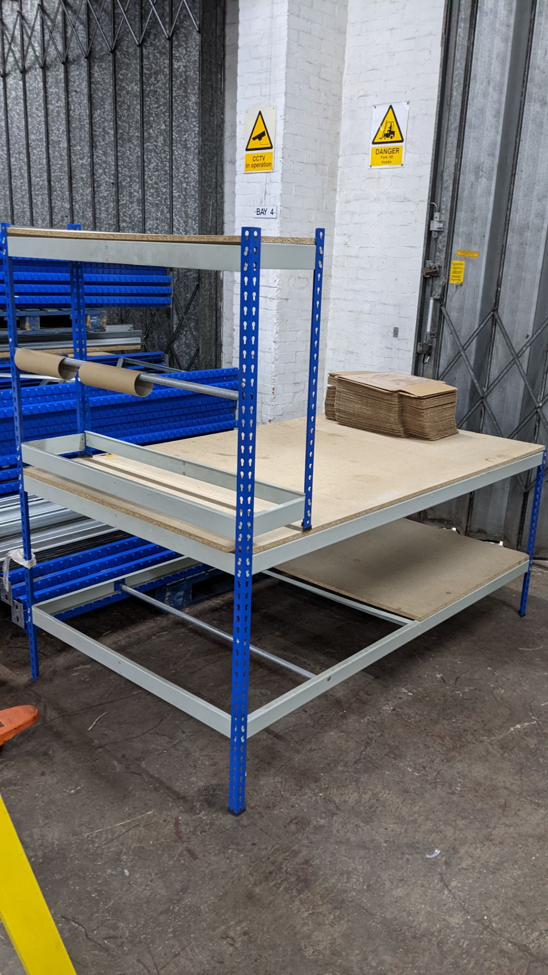 Packing bench with roller dispenser section plus small quantity of flatpack boxes as pictured on top