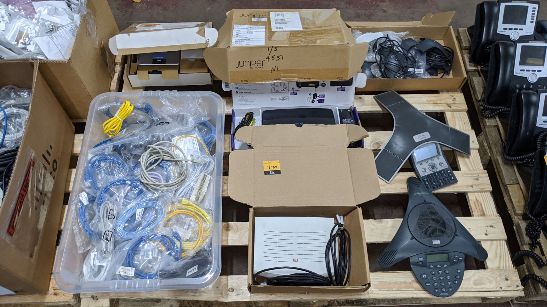 Contents of a pallet of assorted communications items including conference phones, cables, routers &