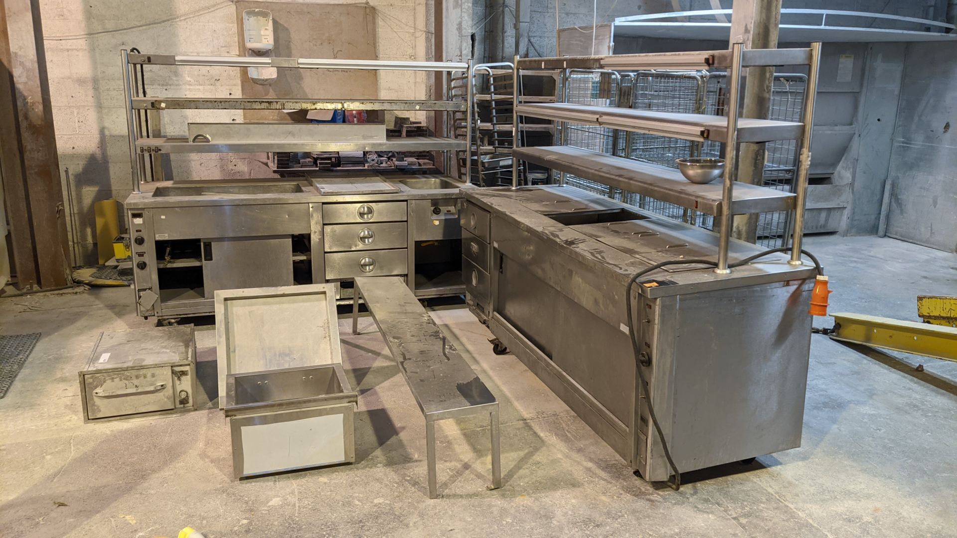 Quantity of commercial catering equipment comprising 2 off large counters, tray trolley, shelving &