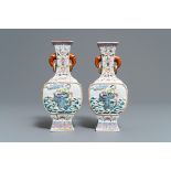 A pair of Chinese famille rose relief-decorated 'Liu Hai' vases, Qianlong mark, 19th C.