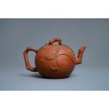 A large Chinese Yixing stoneware teapot with applied grape vines design, Kangxi