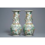 A pair of Chinese Canton famille verte vases with dragon handles, 19th C.