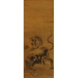 Japanese school, 18/19th C., after Kano Masanobu, ink on silk: A tiger on a rock