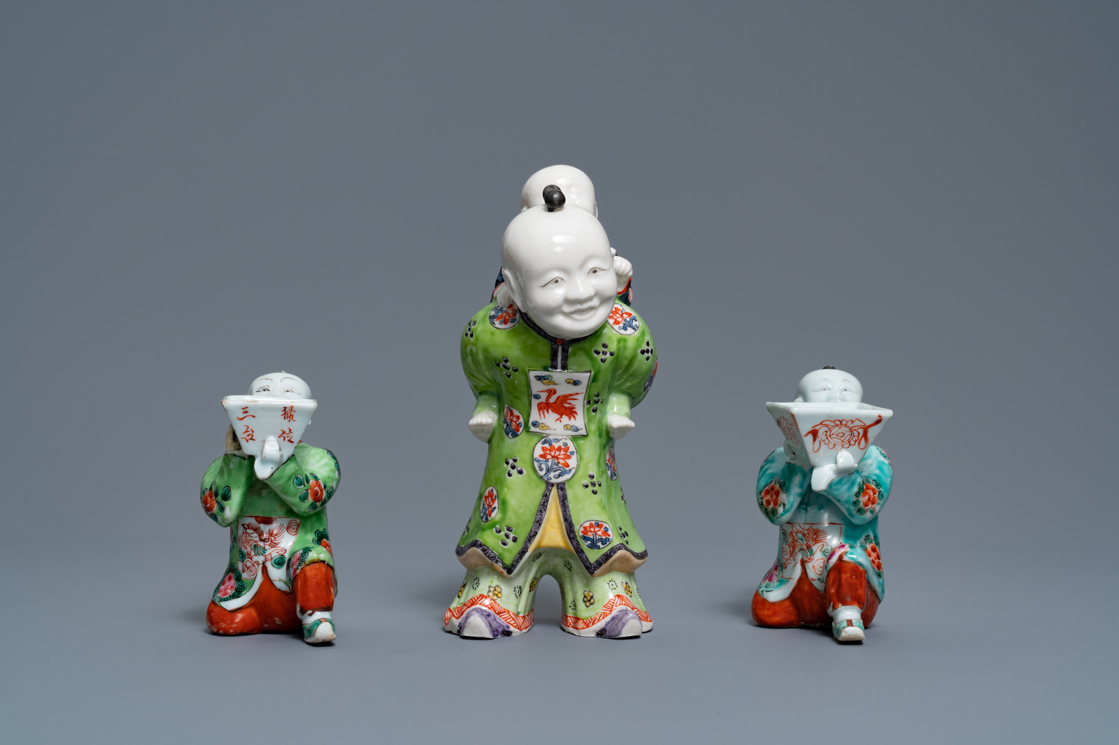 A pair of Chinese blue and white candlesticks and three famille rose figures of boys, 19th C. - Image 11 of 16