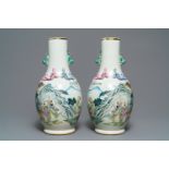 A pair of Chinese famille rose vases with figures in a landscape, 19/20th C.