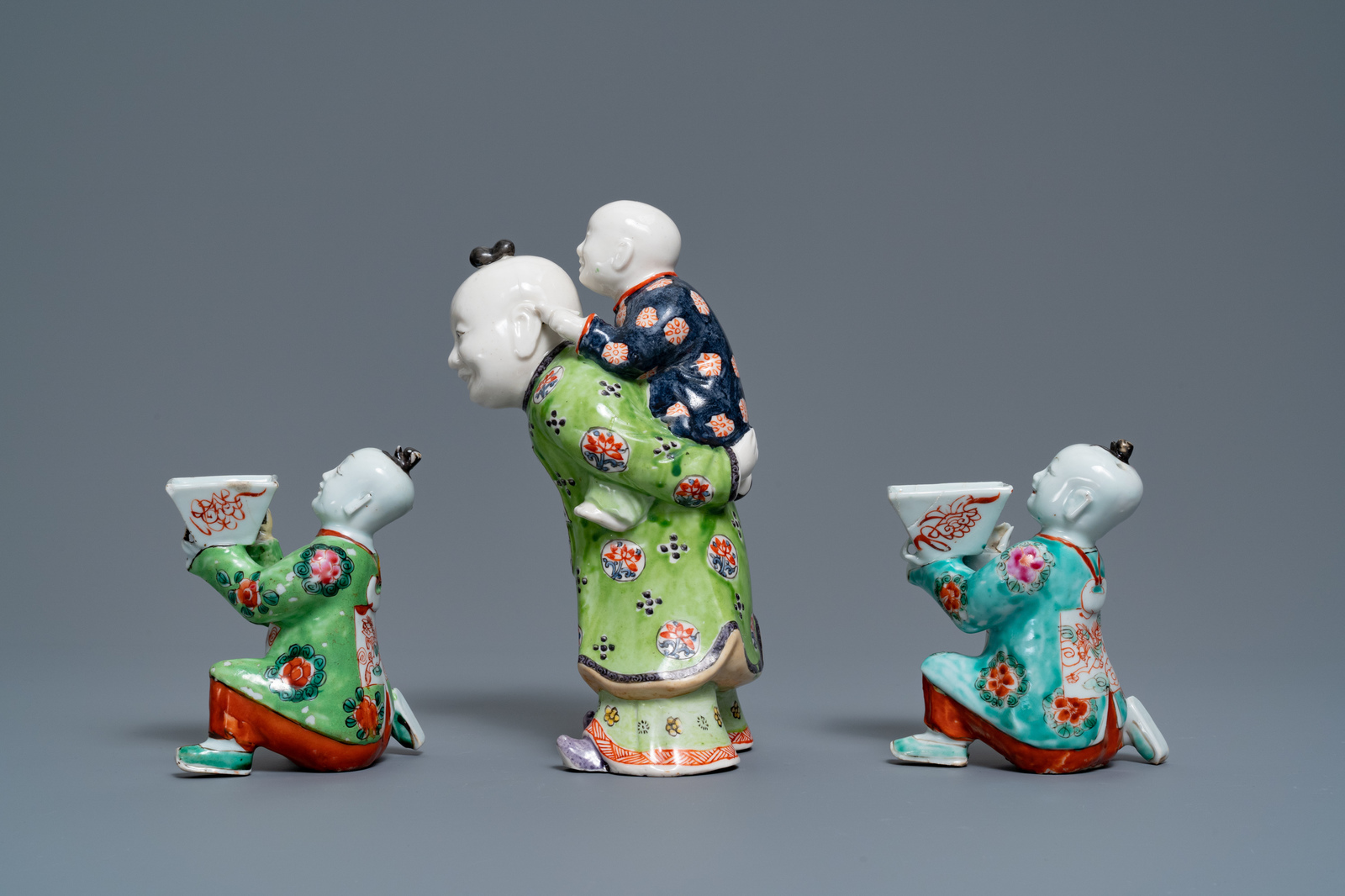 A pair of Chinese blue and white candlesticks and three famille rose figures of boys, 19th C. - Image 12 of 16