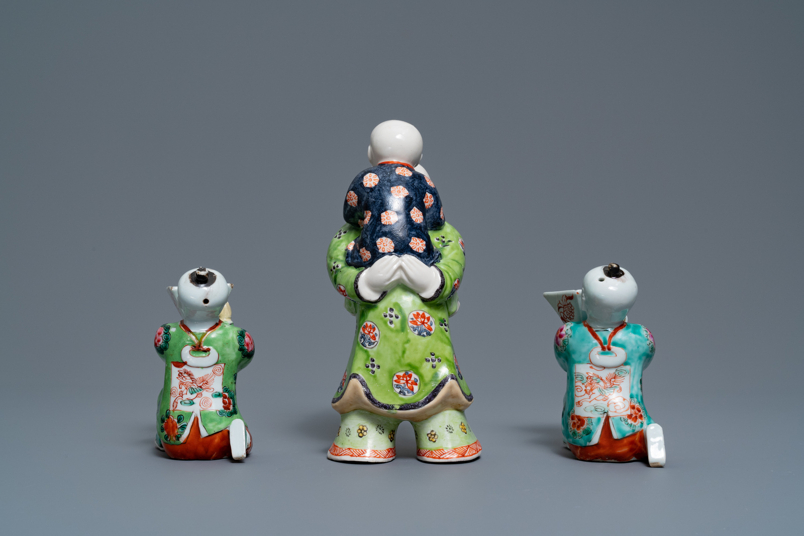 A pair of Chinese blue and white candlesticks and three famille rose figures of boys, 19th C. - Image 13 of 16